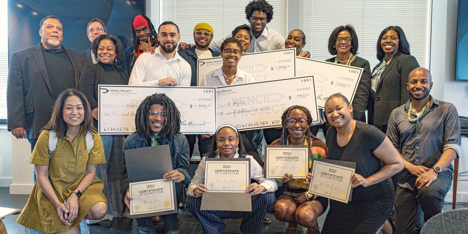 Group of students and faculty displaying scholarship checks