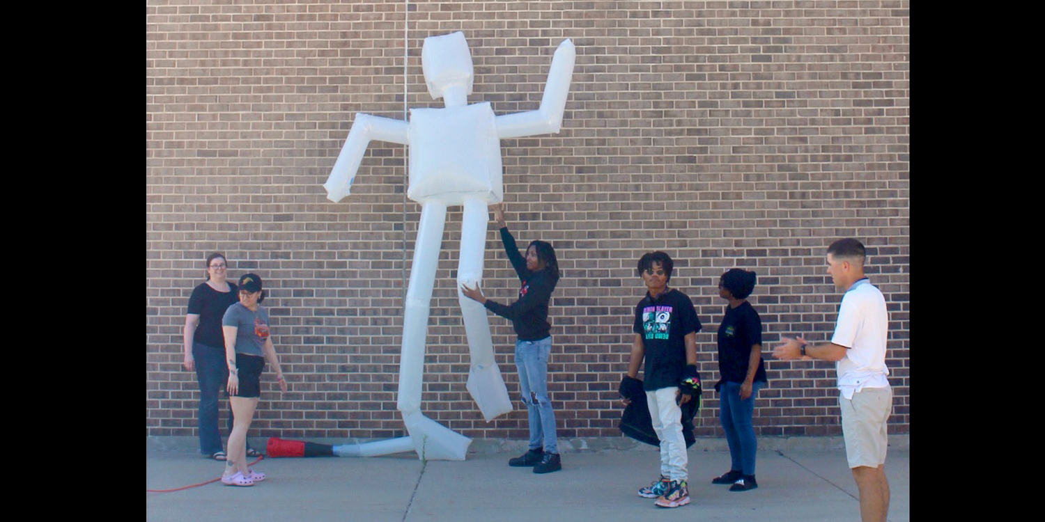 Group of students outside with inflatable sculpture