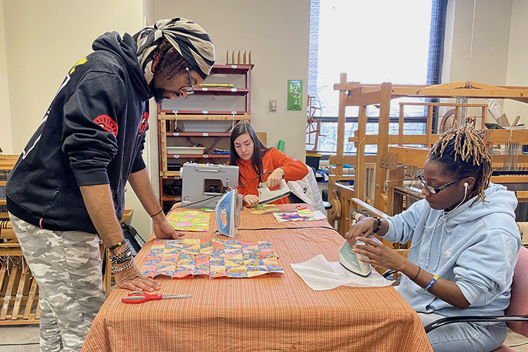 CSU Art and Design Fiber Arts Weaving studio with 3 students creating fiber arts