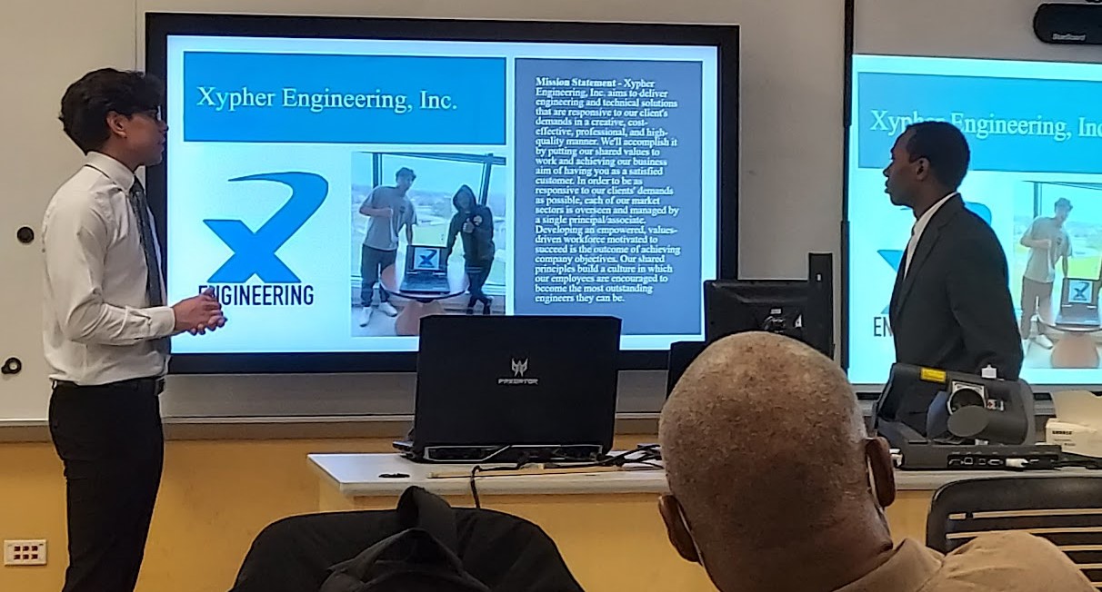 Two engineering students giving a presentation.