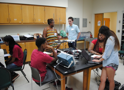 A group of students working in a science lab during the QuarkNet Program at Chicago State University.