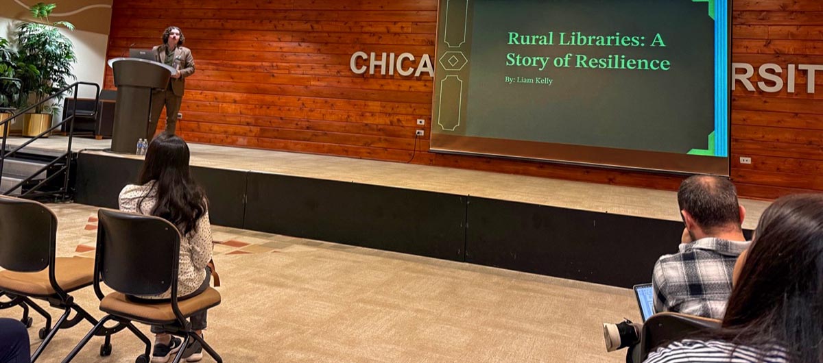 Liam Kelly, library and information science student, presents research titled "Rural Libraries: A Story of Resilience."