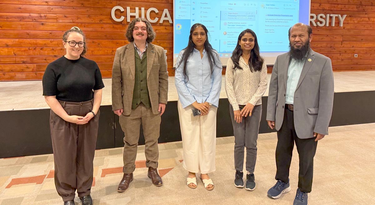 Four student researchers stand next to each other, along with CIMST department chair Dr. Mohammad Abdus Salam.