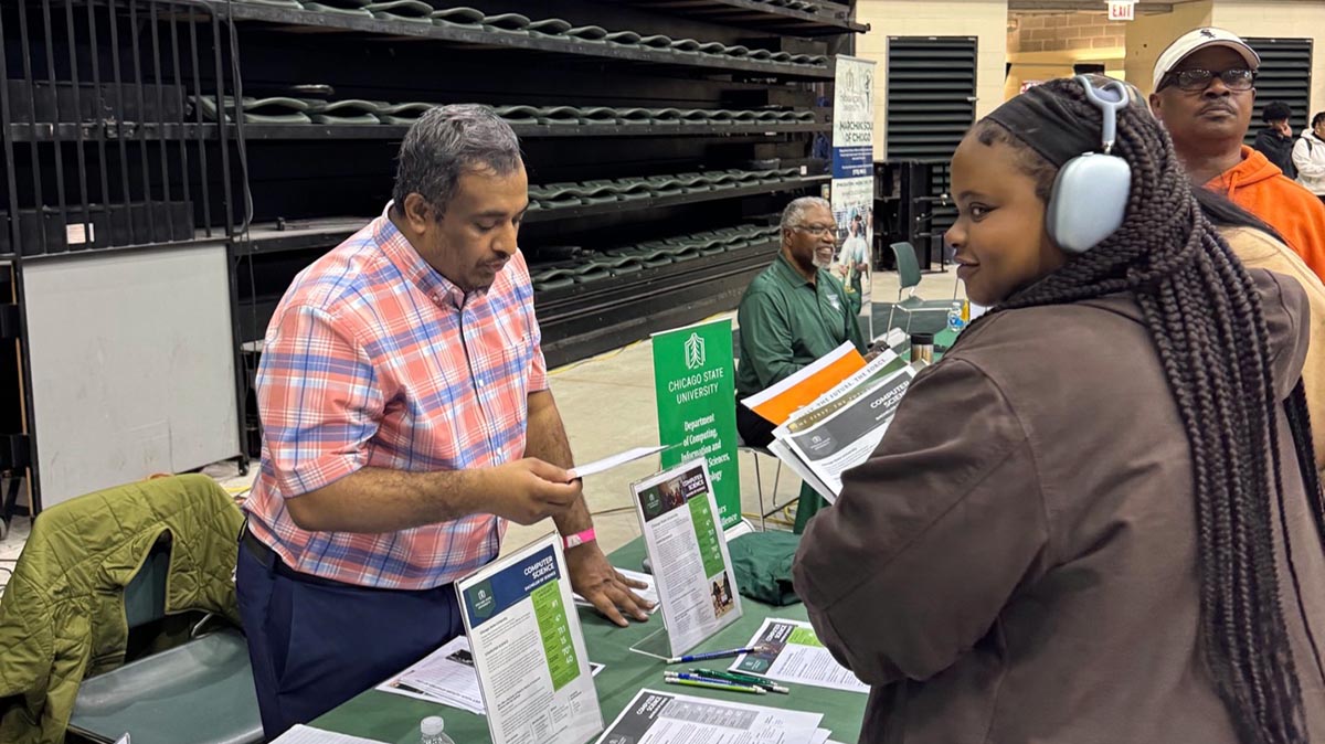 A student speaks with a faculty member at the Black College Expo.