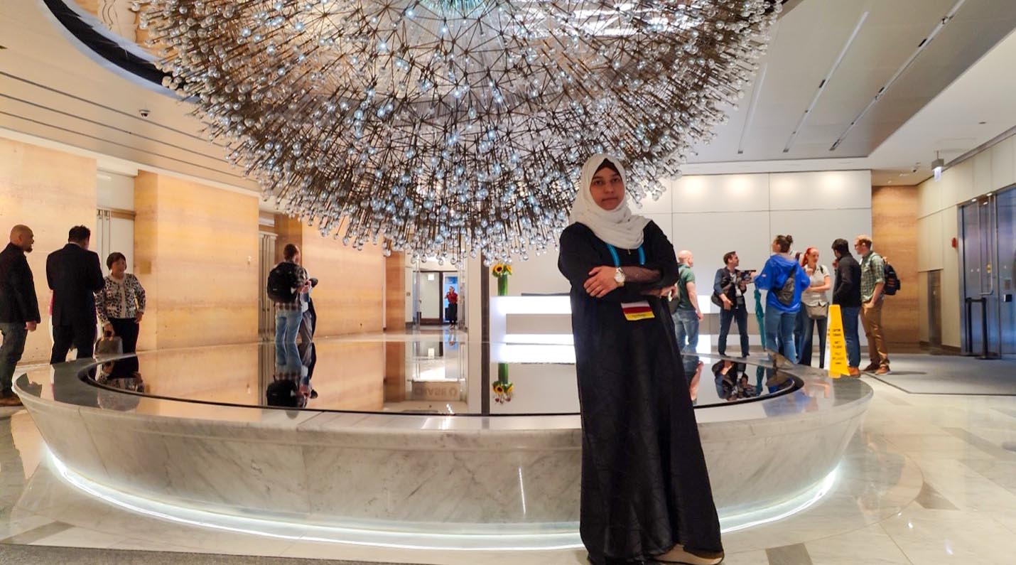 Anees Fatima Anees Fatima standing ny sculpture