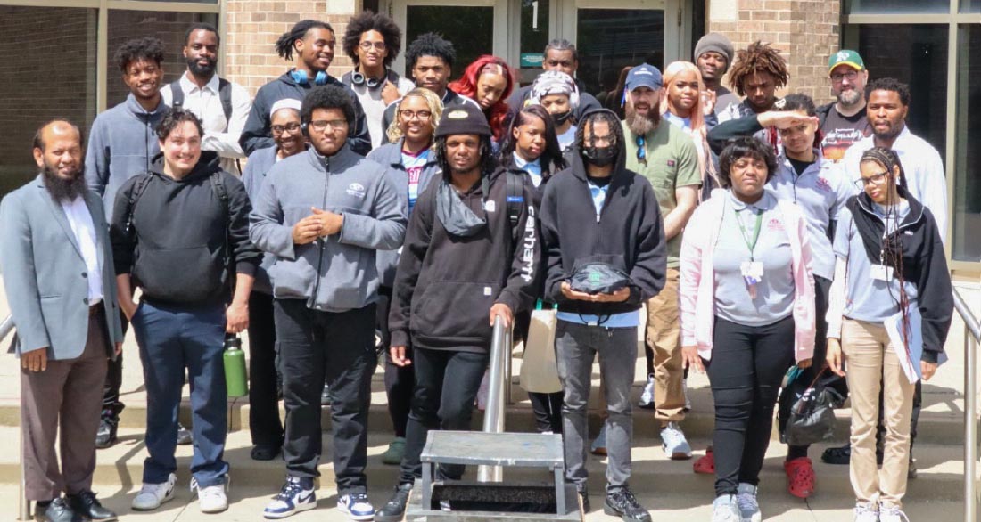 The attendees of Shadow Day stand outside of the Harold Washington Building on CSU's campus for a group photo with CIMST faculty and students.