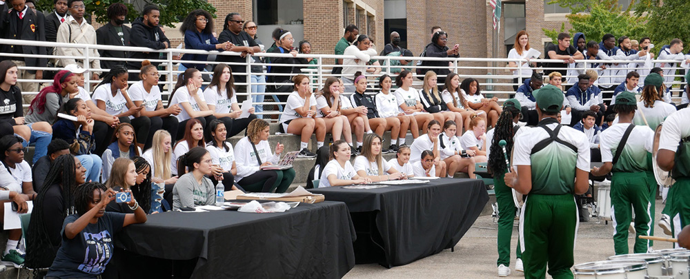 A crowd of students observing a drumline performance during a CSU campus event.