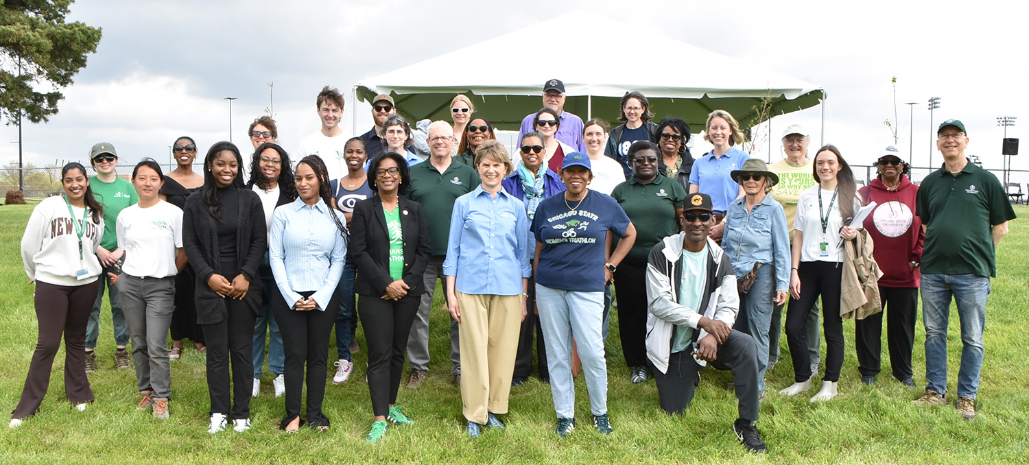 Approximately 30 individuals from Chicago State University and Morton Arboretum take a group photo outside near newly planted trees.