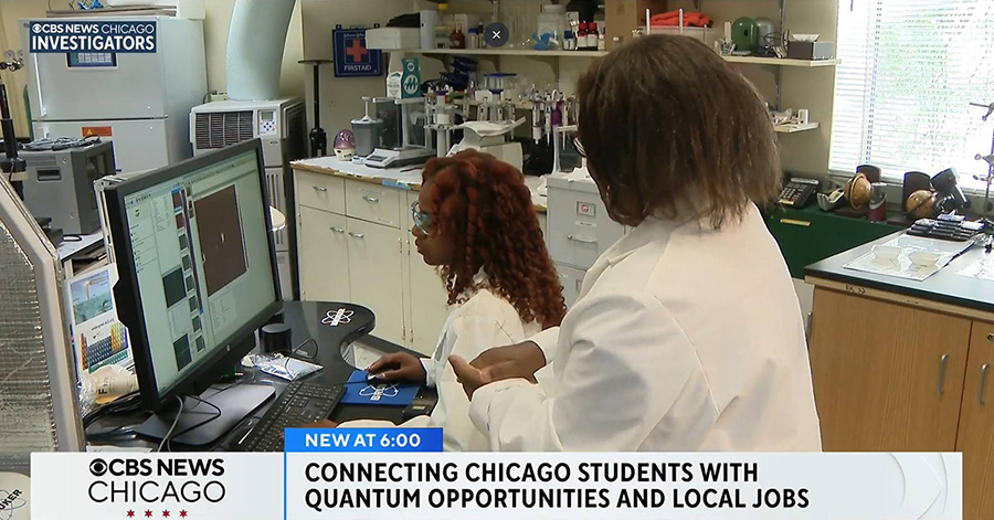 2 female students in lab coats doing research