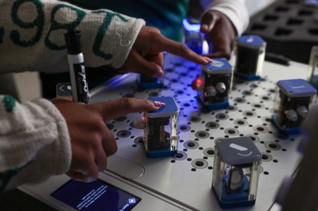 Student Nmari Ward work on a quantum optics laboratory contained in a suitcase called the Quantenkoffer at the Quantum Education, Science & Technology Center at Chicago State University on Sept. 22, 2026. (Stacey Wescott/Chicago Tribune)