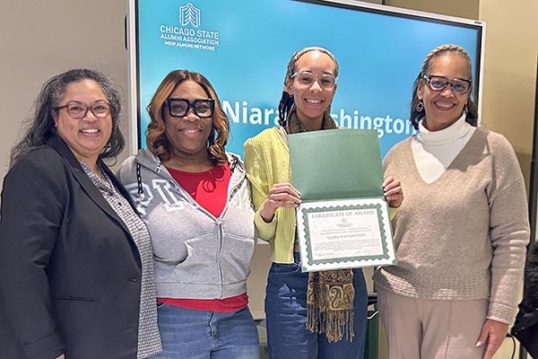 Social Work faculty and pose for a photo with Niara Washington, recipient of the Dr. Mikel Rasheed Memorial Scholarship.